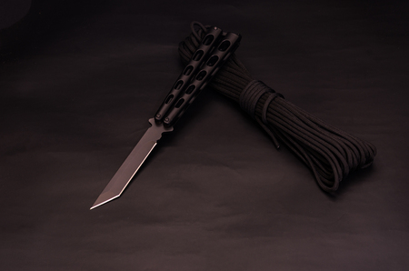 Butterfly knife in working condition. Black on black.の写真素材
