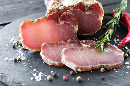 Dried meats with spices and rosemary. Spicy meat. Bright burgundy meat.の写真素材