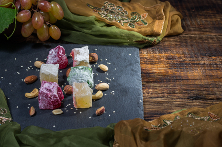 Easten still life. Sweets and nuts. Dark light. Top viewの写真素材