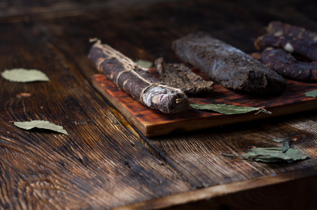 Home-made sausage on the kitchen board. Wooden table.の写真素材