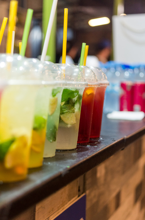 A lot of drinks in a row. Drinks in a glass on the bar. Vertical photo.の写真素材