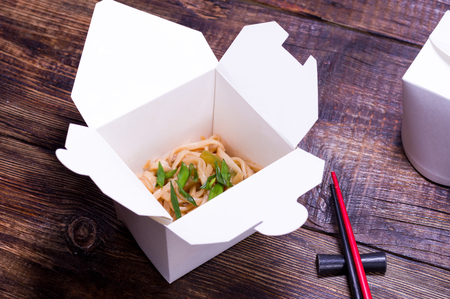 Thai udon noodles. Cooked noodles in a box. Vermicelli and chopsticks.の写真素材