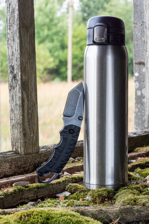 Steel flask and knife. Knife and coffee. Knife and tea.