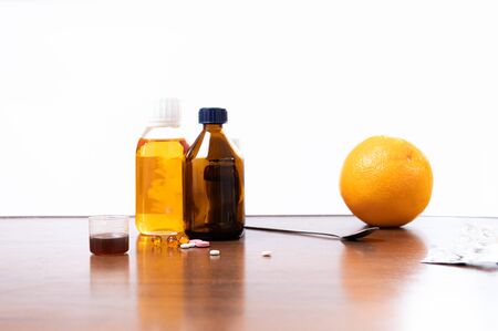Medicines and an orange. Ethnoscience. Home treatment. Combined treatment for colds.の写真素材