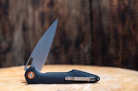 The knife is in a semi-folded position. Curved knife. Front view.の写真素材