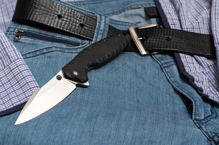 Men's casual style. Knife and jeans. Mens clothing. Blue jeans.