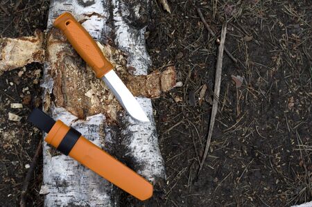 A knife with a fixed blade and a bright orange handle. Bushcraft knife tourist.の写真素材