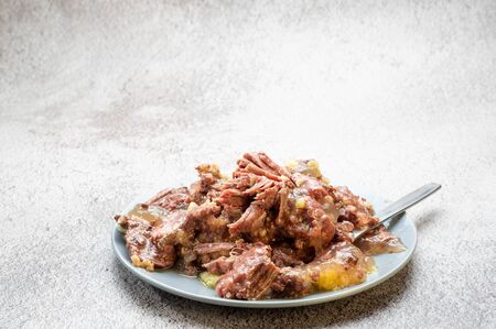 Full plate with meat. Canned meat and fat. A dish of meat only. Angled view.の写真素材