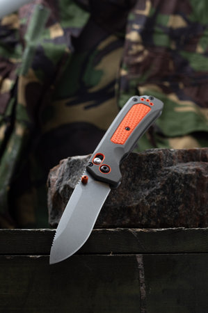 A sharp bright knife for a tourist and a hunter. Hunting knife with an orange handle.