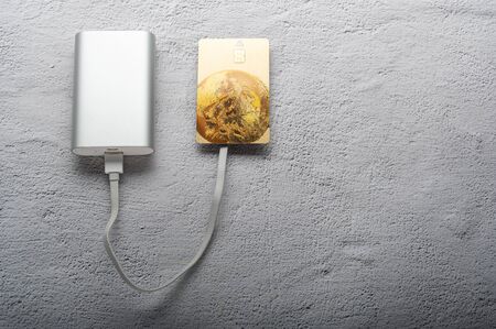 Credit card recharge. Charge a credit card. Power bank and credit card.の写真素材