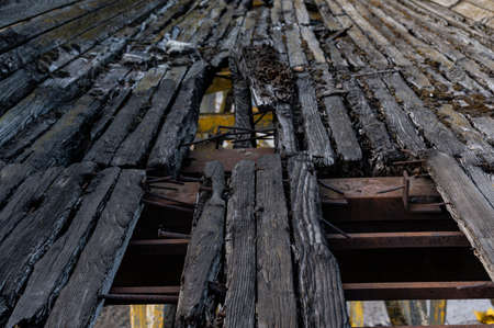 Old wooden boards. Old boards with nails. Burnt boards with nails. Leading lines from boards.の写真素材