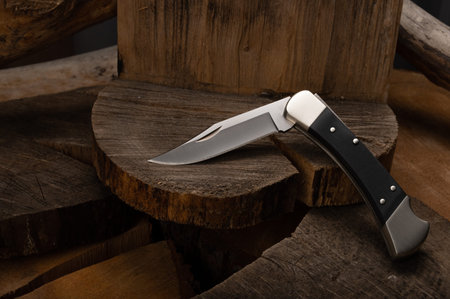 Popular knife in a bent position on a stump.