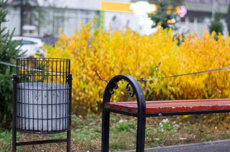Street trash can in the park. Ballot box near the bench. Garbage can in the park.の写真素材