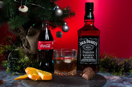 Kyiv, Ukraine - Jan 1, 2020: Jack Daniel's near the tree. New Year's composition. A glass of whiskey...
