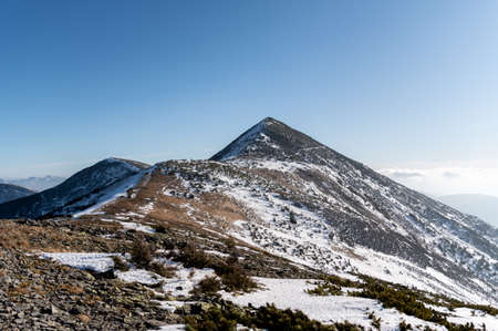 Snow-capped mountain peak. The road to the top of the mountain.の写真素材