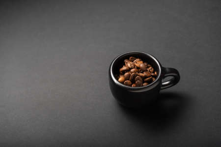 A mug of black coffee. A mug of invigorating coffee. A mug of strong coffee. Low key.の写真素材