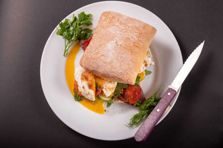 Sandwich with white bun and poached egg. Sandwich and knife.の写真素材