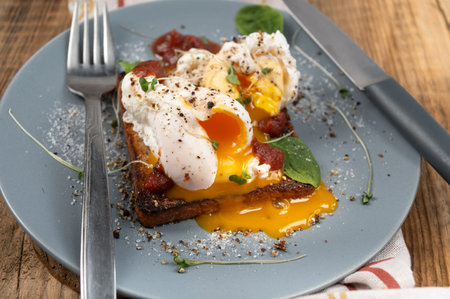 Poached eggs with spread yolk. Egg yolk on a plate.