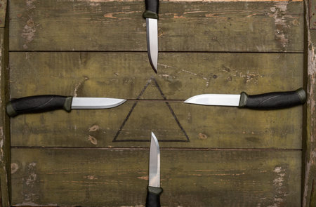 Several knives directed to the center. Sharp knives flying to the center.