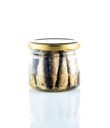Isolate of a glass jar with sprats. Fish in a glass jar. Front view.の写真素材
