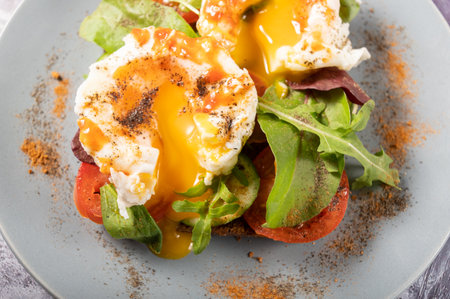 Spreading yolk. Spreading yolk in poached eggs. Macro.の写真素材