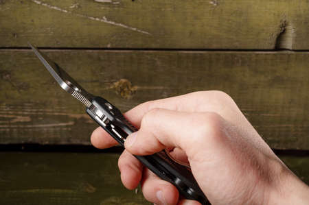 The user clicks on a button. The user closes the knife lock. Vertical frame.の写真素材