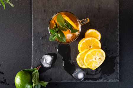 Iced tea with lemon. Mint leaves and melted ice cubes. Top.の写真素材