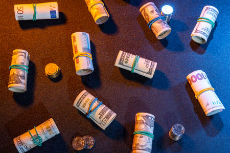 Money scattered across the table. Paper and iron money on the table. Diverse currency.の写真素材