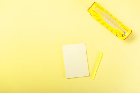 Yellow notepad on a yellow table. Yellow items. Yellow office.の写真素材
