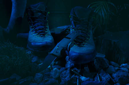 Military shoes and knife. Military composition with a knife. Moonlight on the shoe. Front view.の写真素材