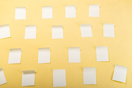 Lots of stickers pasted. Stickers for notes. Stickers on a yellow background.