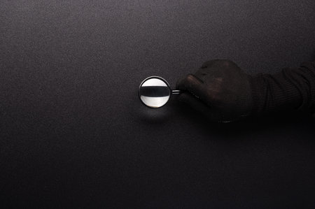 Magnifier in hand. Black hand holds a magnifier. Look for little things and details. Black...
