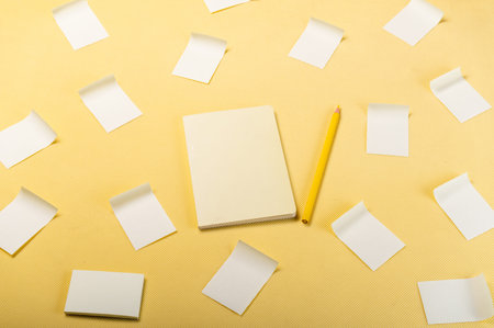 Yellow notepad and yellow pencil.