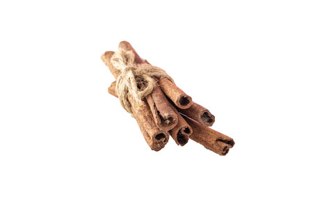 Cinnamon sticks are tied in a bunch. Cinnamon sticks are tied in a bunch. Isolated cinnamon. Front...