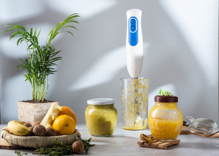 Making jam with a blender. Honey ginger jam. Food and accessories in the kitchen. Pot and shade of...