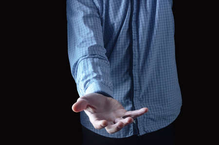 Outstretched hand of a man. A man in a plaid shirt. Hand with an open palm. Front view.の写真素材