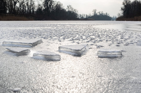 Chunks of frozen ice. Ice chunks on ice. Severe frost outside. The frozen river. Daylight.