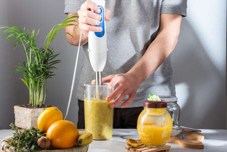 Rub the lemon and ginger. Grind honey and ginger with a blender. Crush lemon and ginger in a blender.の写真素材