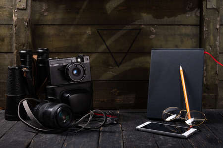 Photo technician and notebook. Camera and binoculars. Technique for observation and recording.の写真素材