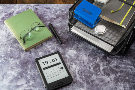 E-book on the table. Office and book on the table. Diary on the work table. Calendar on the desktop.