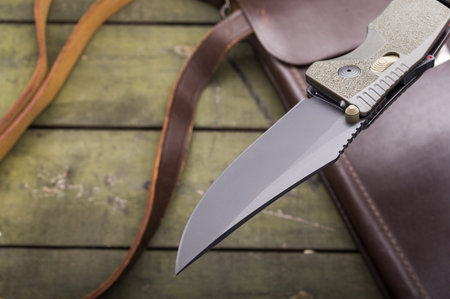 The blade of the knife is pierced in the air. Knife over the table. Knife over the bag. View from...