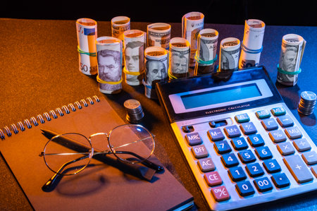 Various currency and notepad. Money and calculator. Currency exchange and calculator. View from above.の写真素材