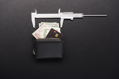 Measuring finance. Budget measurement. Caliper and wallet. Money and credit card. View from above.の写真素材