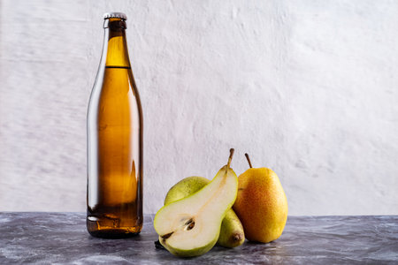Yellow glass bottle with drink. Bottle and fruit. Citro and pears. Sparkling water and pears.の写真素材