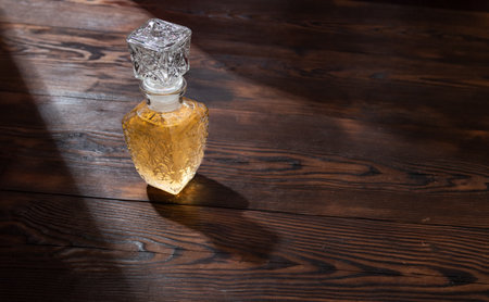 Glass decanter with drink. Whiskey in a decanter. Alcohol in a glass decanter with a pattern. View from above.の写真素材