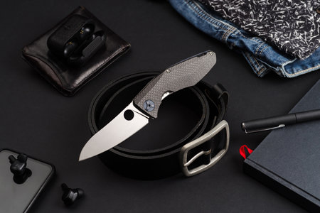 Still life with a knife. Knife and mens items. Mens clothing and accessories. Neatly folded items.の写真素材