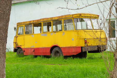 Yellow passenger bus. Old Soviet bus. Side view of the bus from the back.