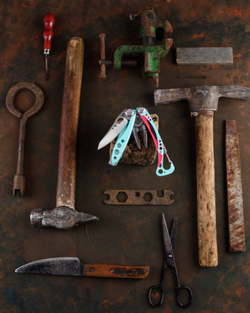 Beautiful new knife and old tools. Old rusty tools around the new knife. Vintage and new. Vertical...