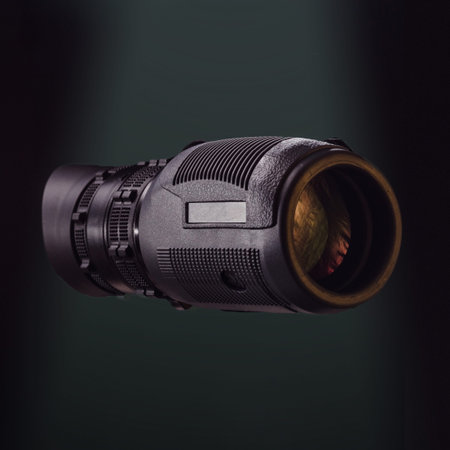 Black monocular on green photo. Beautiful photo of a monocular. Optics for hunters and tourists....