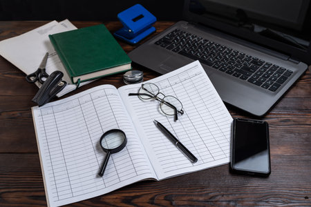 Office and stationery. Stationery items on the table. Desk in the office. Laptop and notebook on the...